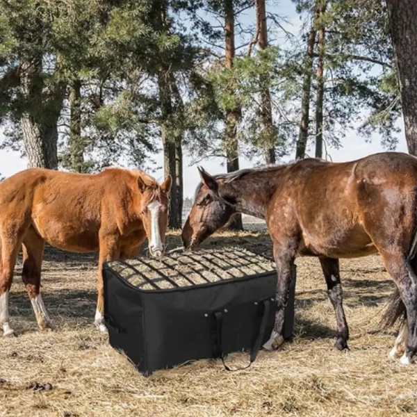 Slow feed horse hay bag in use reducing waste during feeding in pasture